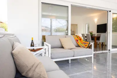 a living room with a couch and a table at Cube 67 - Garden in Palermo