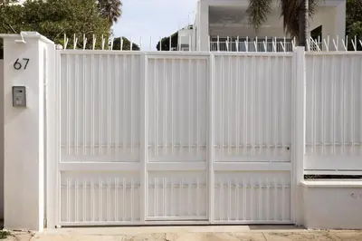 a white fence in front of a house at Cube 67 - Garden in Palermo