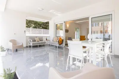 a living room with white furniture and a table and chairs at Cube 67 - Villa in Palermo
