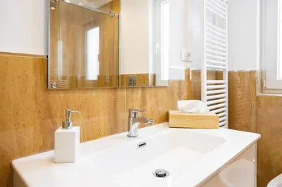 a bathroom with a sink and a mirror at Cube 67 - Villa in Palermo