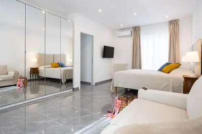 a hotel room with two beds and a mirror at Cube 67 - Villa in Palermo