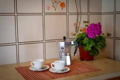 a counter with two cups and a blender on a table at A casa di Mara in Mondello