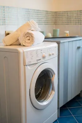 a washing machine with towels on top of it at A casa di Mara in Mondello