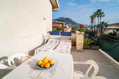 a table with a bowl of oranges on a balcony at A casa di Mara in Mondello