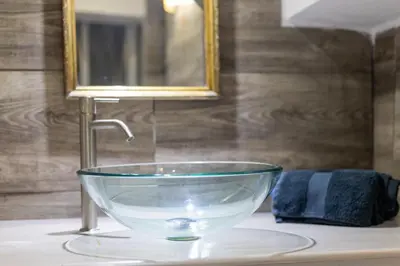 a glass bowl sitting on top of a bathroom sink at Caveau in Palermo