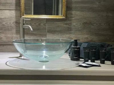 a glass bowl sink on a counter in a bathroom at Caveau in Palermo