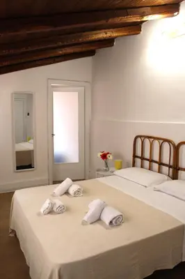two beds in a room with towels on them at Terrasini 2000 Home Holidays in Terrasini