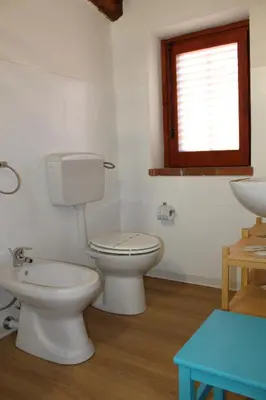 a bathroom with two toilets and a sink and a window at Terrasini 2000 Home Holidays in Terrasini