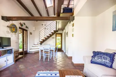a living room with a couch and a table at Villetta Rosamarina by Wonderful Italy in Cefalù