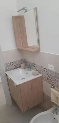 a bathroom with a sink and a mirror at A Casa Ri Angela in San Vito lo Capo