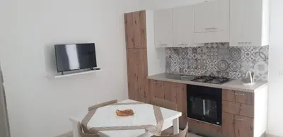 a kitchen with a table and a small table and a stove at A Casa Ri Angela in San Vito lo Capo
