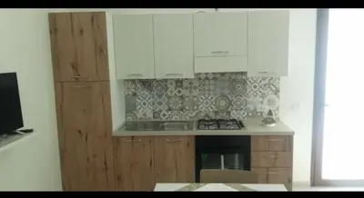 a kitchen with white cabinets and a stove at A Casa Ri Angela in San Vito lo Capo