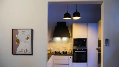 a kitchen with a picture of a woman with love at Le Maioliche Apartment in Palermo