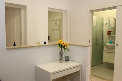 a bathroom with a vase of flowers on a table at La terra del sole in Cinisi