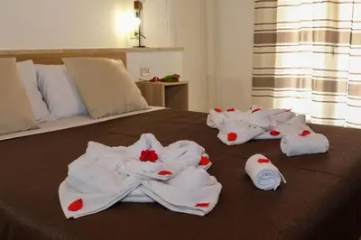 a group of towels on a bed in a room at La terra del sole in Cinisi