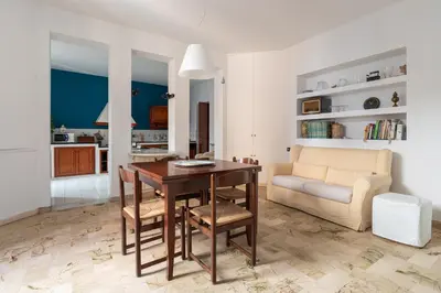 a living room with a table and a couch at Palazzo Damiani Apartment by DomuSicily in Palermo