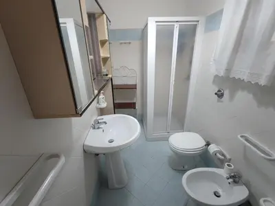 a bathroom with a sink and a toilet and a shower at Casa Conchiglia in San Vito lo Capo