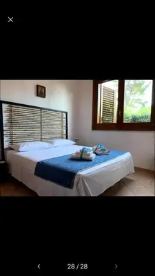 a bedroom with a bed with two towels on it at Màkari in Macari