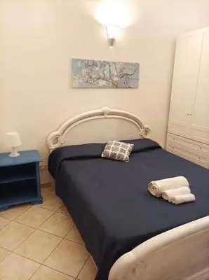 a bedroom with a bed with two towels on it at Amuri Siculo, Casa Vacanze Palermo centro in Palermo