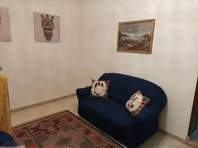 a blue couch with pillows on it in a room at Amuri Siculo, Casa Vacanze Palermo centro in Palermo