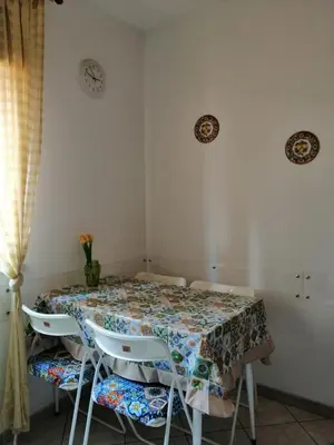 a dining room table with chairs and a table cloth at Amuri Siculo, Casa Vacanze Palermo centro in Palermo