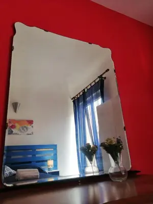 a mirror sitting on a table in a room at Amuri Siculo, Casa Vacanze Palermo centro in Palermo