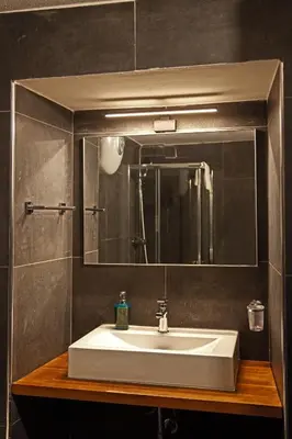 a bathroom with a white sink and a mirror at Palermo alla Gancia Room in Palermo