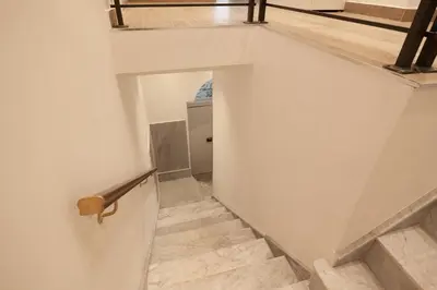 a staircase in a house with white walls and wood floors at Aragona15 Suites in Palermo