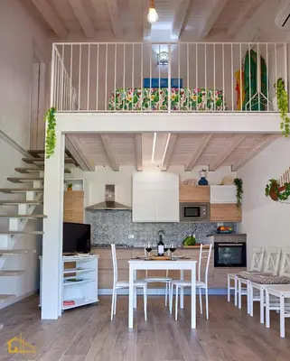a kitchen and dining room with a loft bed at Violisa Charme in Castellammare del Golfo