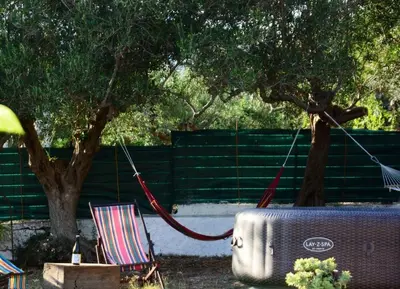 a hammock tied to a tree in a yard at Violisa Charme in Castellammare del Golfo