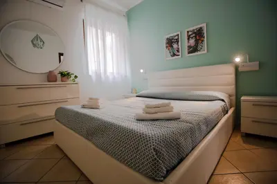 a bedroom with a bed with towels on it at Cassaro Casa Vacanze in Castellammare del Golfo
