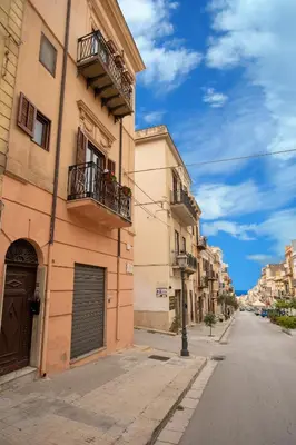 an empty street in a city with buildings at Cassaro Casa Vacanze in Castellammare del Golfo