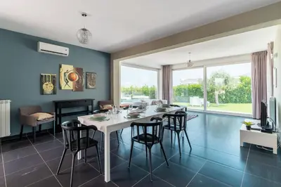 a dining room with a white table and chairs at Nuova Villa a Scopello con piscina privata in Balata di Baida