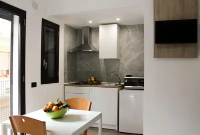 a kitchen with a table with a bowl of fruit on it at Case Carà 128, Appartamentini nel cuore di Bagheria, Piano Primo in Bagheria
