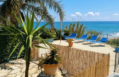 a view of a beach with sailboats in the water at Fronte Mare in Castellammare del Golfo