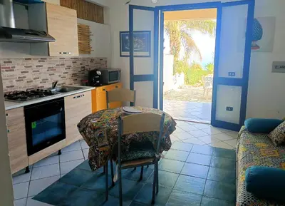 a kitchen with a table and a kitchen with a couch at Fronte Mare in Castellammare del Golfo