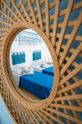 a mirror reflection of a bedroom with two beds at Le Vele Mondello, villa a due passi dal mare in Mondello