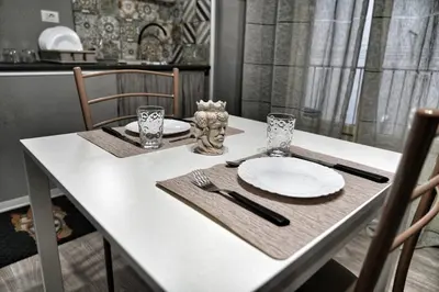 a white table with a white plate on it at La Casa del Moro - Al Politeama in Palermo