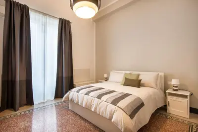 a white bedroom with a bed and a mirror at Casa Rorro' nei pressi di Via Roma by Wonderful Italy in Palermo