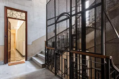 a hallway with a door open to a living room at Casa Rorro' nei pressi di Via Roma by Wonderful Italy in Palermo
