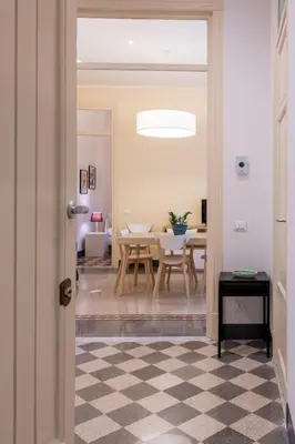 a living room with a table and a couch at Casa Rorro' nei pressi di Via Roma by Wonderful Italy in Palermo
