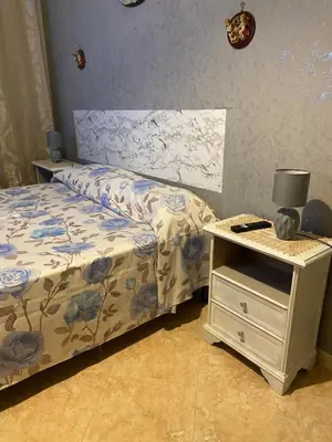 a bedroom with a bed and a nightstand with a bed sidx sidx sidx sidx at Casa vacanza Giusi in Palermo