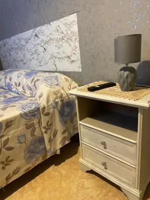 a bedroom with a bed and a nightstand with a lamp at Casa vacanza Giusi in Palermo