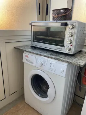 a microwave on top of a washing machine in a kitchen at Casa vacanza Giusi in Palermo