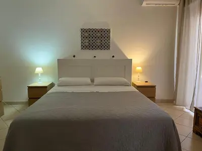 a bedroom with a large bed with two lamps at Dal Porto al Politeama in Palermo