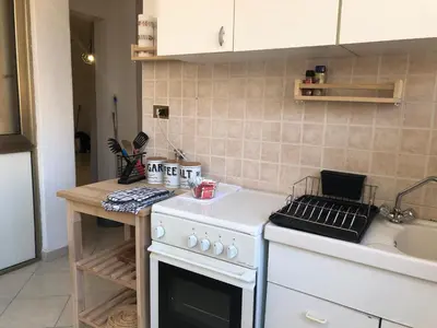 a kitchen with a white stove top oven next to a sink at Dal Porto al Politeama in Palermo