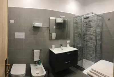 a bathroom with a sink and a shower and a toilet at Dal Porto al Politeama in Palermo