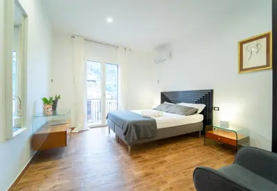 a bedroom with a bed and a couch at Civico64 apartments in Castellammare del Golfo