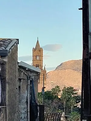 an old building with a clock tower in the distance at Lovely Apartment in the City Centre in Palermo