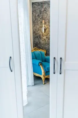 a blue chair in a room with a wall at Le Stanze del Conte in Palermo